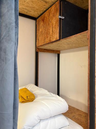 a bedroom with a bunk bed with a wooden cabinet at Spanglish Hostel Benidorm in Benidorm