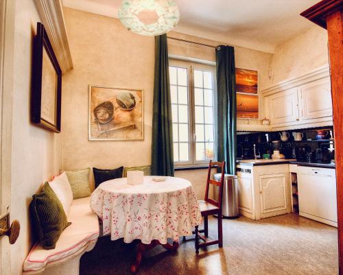 a living room with a table and a kitchen at Les Remparts Antibes Location in Antibes
