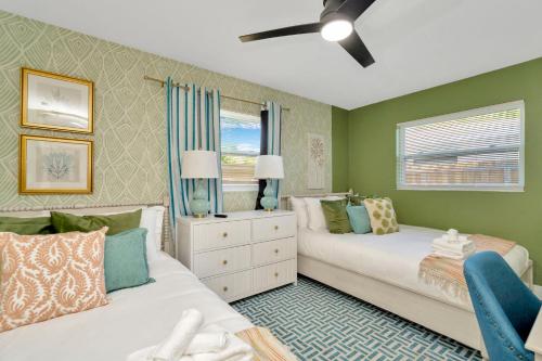 a bedroom with two beds and a window at Breezy Pineapple, Heated Pool, Sleeps 12, Putting Green in Largo
