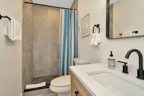 a bathroom with a sink and a toilet and a shower at Breezy Pineapple, Heated Pool, Sleeps 12, Putting Green in Largo