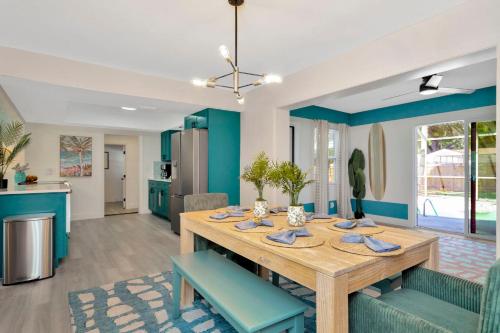 a dining room with a table and blue walls at Breezy Pineapple, Heated Pool, Sleeps 12, Putting Green in Largo