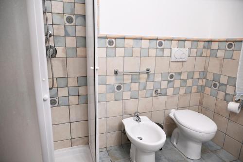 a bathroom with a toilet and a sink at Casa Stella Marina by Bianco Puglia Vacanze in Specchiolla 