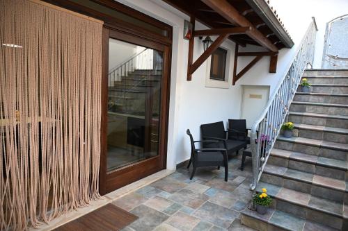 a patio with two chairs and a sliding glass door at Casa Stella Marina by Bianco Puglia Vacanze in Specchiolla 