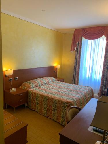 a hotel room with a bed and a window at Hotel La Bussola in Orta San Giulio