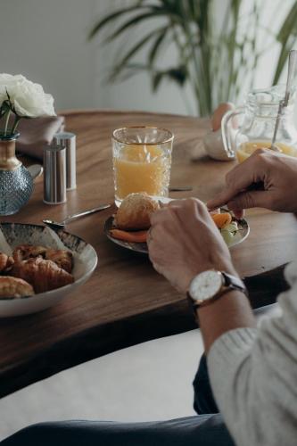 a person sitting at a table with a plate of food at Au Porte Bonheur in Zwalm