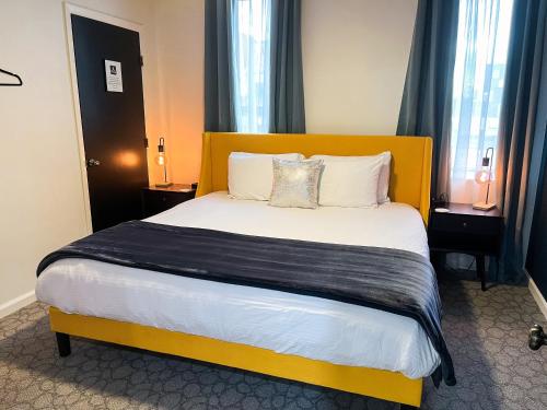 a bedroom with a large bed with a yellow headboard at The Baker The Archive Lofts in Marion