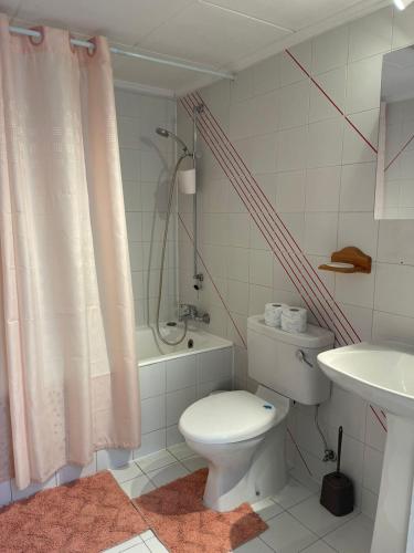 a bathroom with a white toilet and a sink at Limnaria Westpark 2 bdrm apartment 122 in Paphos