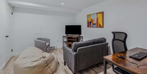 a living room with a couch and a table at Steps to Ski Trail Fireplace - Kingswood 1B in Quechee