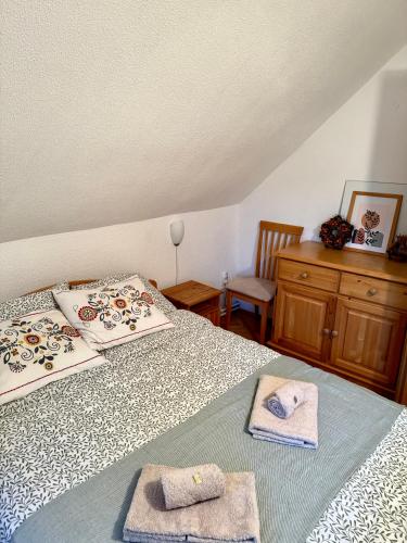 a bedroom with two beds with towels on them at Katja Cottage in Bohinjska Bela