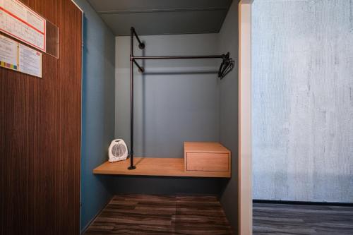 a closet with a wooden shelf and a box at Ibis Styles Linz in Linz