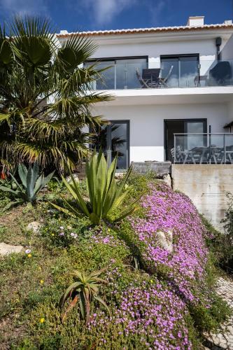 a house with pink flowers in front of it at maresoul - Ferienapartment soul in Raposeira