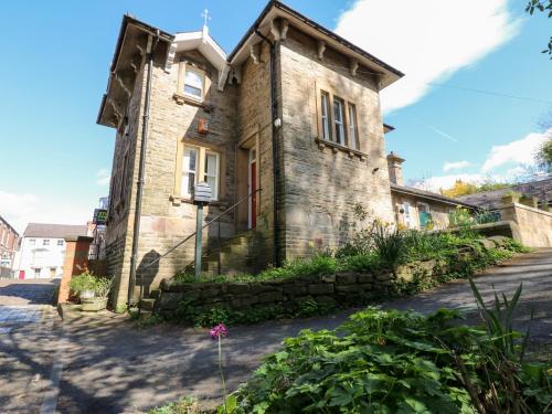 an old stone house with a stone wall at Leazes Cottage in Durham