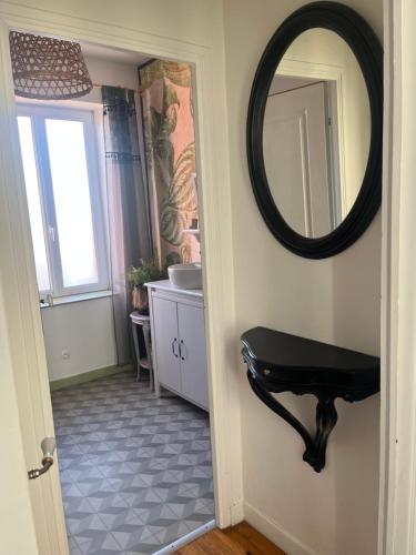 a bathroom with a mirror and a sink at Maison de Ville in Saint-Christophe-du-Ligneron