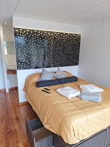 a bed with two pillows on it in a room at Pinares de Cacheuta in Las Heras