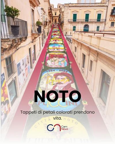 a long escalator in a city with the words noto at Pomillo Rooms in Noto