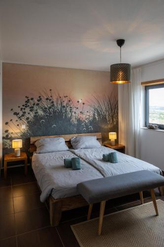a bedroom with a large bed with two pillows on it at maresoul - Ferienapartment soul in Raposeira