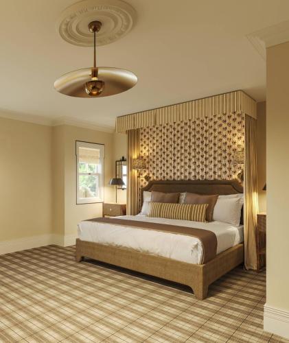 a bedroom with a large bed and a ceiling at The Asticou Hotel in Asticou