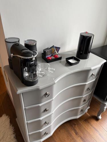 a white dresser with a coffee maker on top of it at Headland View Boutique B&B in Torquay