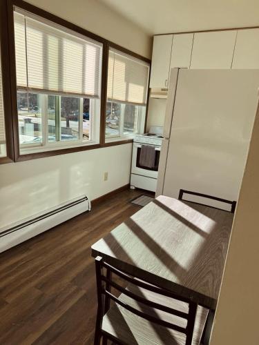 an empty kitchen with a table and a refrigerator at Liberty Valley Studio - 1001-29 in Madison