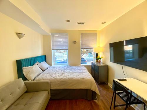 a bedroom with a bed and a couch at Cozy Home in the Heart of South Philly in Philadelphia