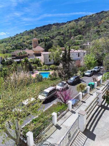 a group of cars parked in a parking lot at Casa Rural hasta 14 personas Alpujarra Granadina, La Almazara in Mecina Fondales
