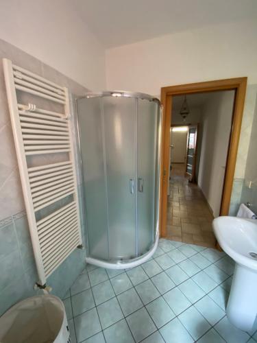 a bathroom with a shower and a toilet and a sink at Regina House Cattolica in Cattolica