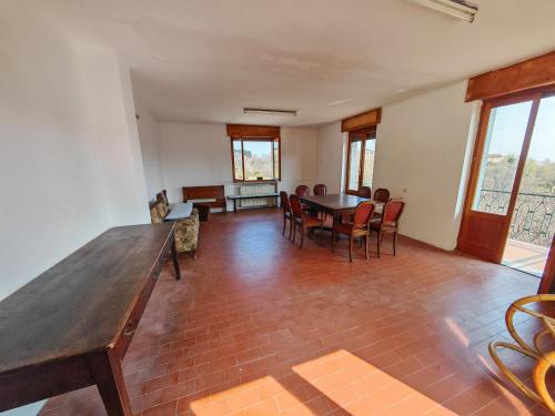 a living room with a wooden table and chairs at Casale Valdilana in Mosso Santa Maria