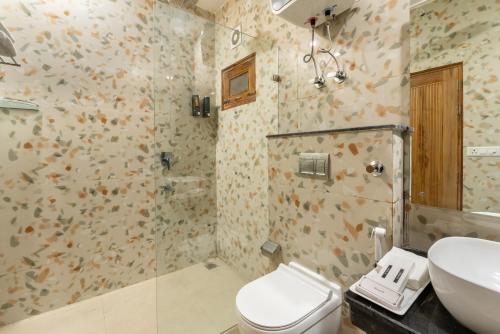a bathroom with a toilet and a sink at Lime Tree Hotel & One Bed Room Serviced Apartment - Noida Next to Sector 50 Metro with Party Venue in Noida