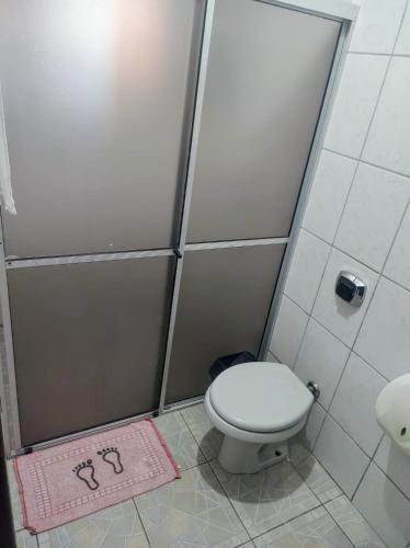 a bathroom with a toilet and a shower stall at Pousada Amigu's in Pontal do Paraná