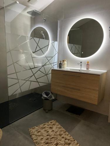 une salle de bain avec un lavabo et un miroir dans l'établissement Maison neuve cocooning 6 personnes Avec Spa et piscine chauffée, à Moyenmoutier