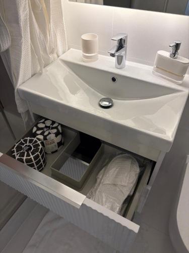 a bathroom with a white sink in a room at Headland View Boutique B&B in Torquay