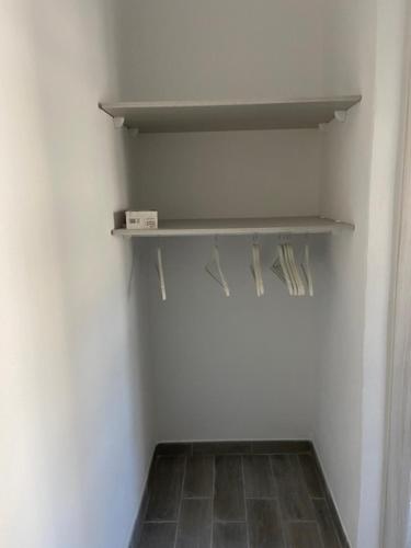 a shelf in a room with a white wall at La Giara in Alghero