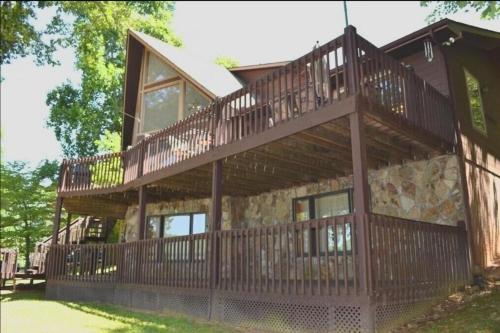 a large wooden house with a large deck at Sunset Dreams-Norris Lake in La Follette