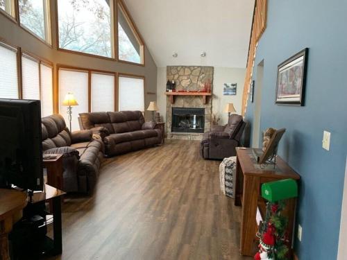 a living room with a couch and a fireplace at Sunset Dreams-Norris Lake in La Follette