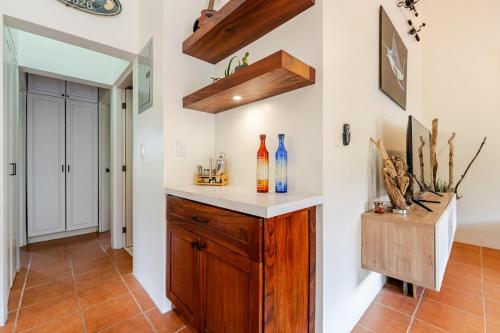a kitchen with a counter with bottles on it at Casa Fe- Newly Renovated 2 bedroom condo in Ocotal