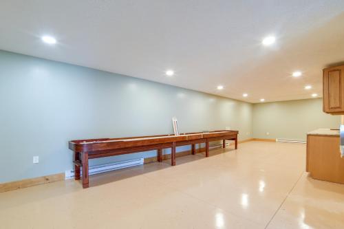 an empty room with a piano on the wall at Home with River View and Game Room in Tidioute! in Tidioute