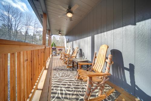 a row of rocking chairs on a porch at Home with River View and Game Room in Tidioute! in Tidioute