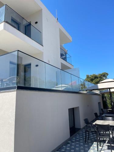 a balcony of a house with a table and chairs at Hotel Aluor in Vlorë