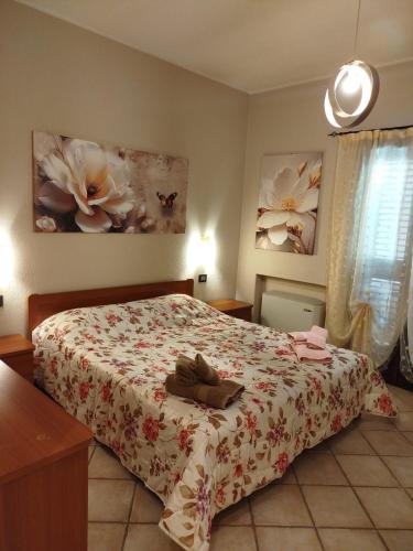a bedroom with a bed with a floral bedspread at SeaHouse Villasimius in Villasimius