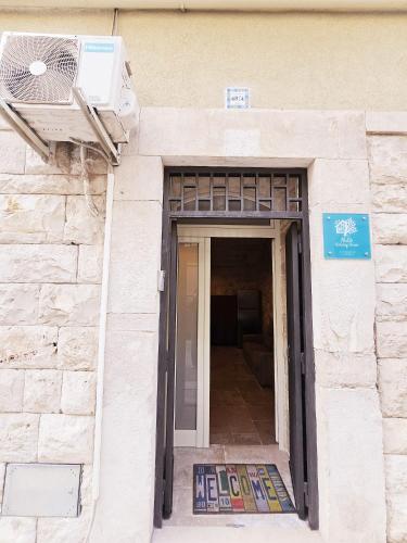 a door to a building with a fan on it at Nilò holiday house in Molfetta
