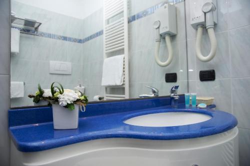 a bathroom with a blue counter and a sink at Hotel La Bussola in Orta San Giulio