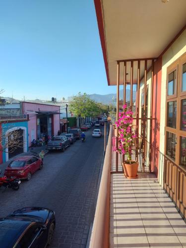 a view from a balcony of a street with cars at Lidia Anturios Suites in Oaxaca City