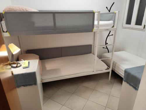 a room with two bunk beds and a table at Mimi family in Florence