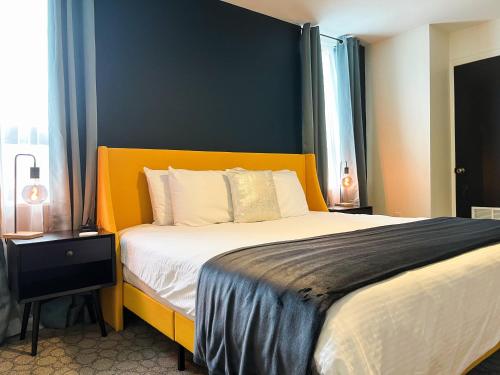 a bedroom with a large bed with an orange headboard at The True The Archive Lofts in Marion