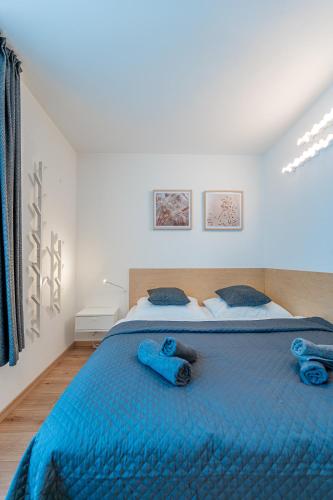 a bedroom with a blue bed with blue towels on it at Bastion New Apartment with Parking in Košice