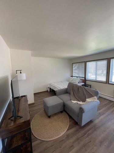 a living room with a couch and a bed at Liberty Valley Short Term Rental - 27 in Madison