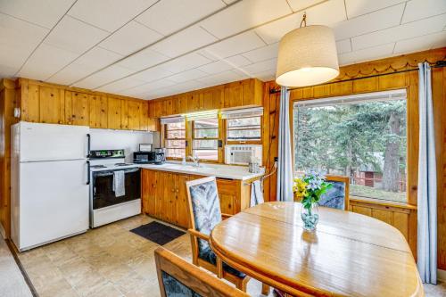 a kitchen and dining room with a wooden table at Mountain Retreat at Base of Pikes Peak! in Cascade-Chipita Park