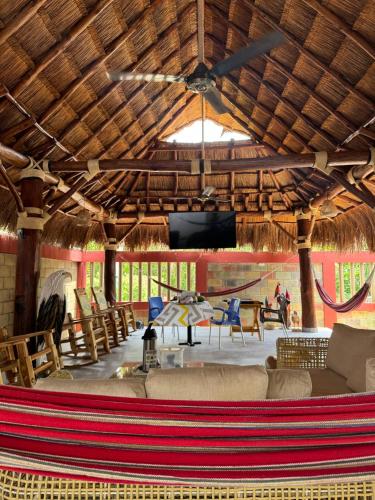 a living room with a couch and a table and a television at Cabaña La Roca in San Antero