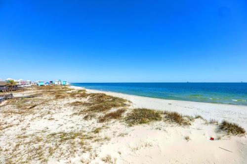 an empty beach with the ocean in the background at Surf Song S1 in Fort Morgan