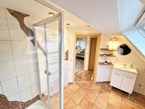 a bathroom with a glass shower in a room at Superior Duplex Apartment - nur 5 min vom Europa-Park in Rheinhausen